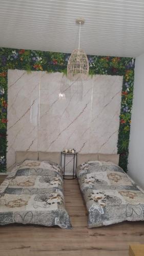 a bedroom with a bed and a wall with flowers at Panama Apartments in Krefeld