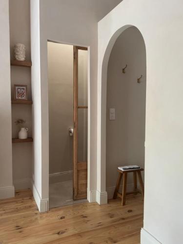 a hallway with a door and a stool in a room at Chambre d'hôtes Villa Calys in Claira