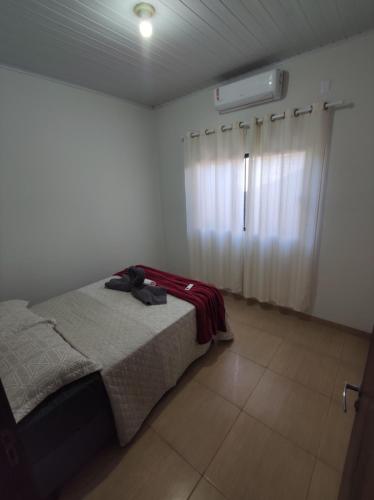 a bedroom with a bed and a window at Casa da Nonna in Palmas