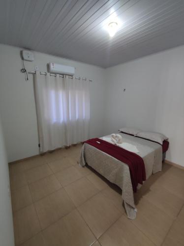 a bedroom with a bed in a white room at Casa da Nonna in Palmas