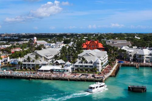 a boat in the water next to a pier at Fitch Lodge - Key West Historic Inns in Key West
