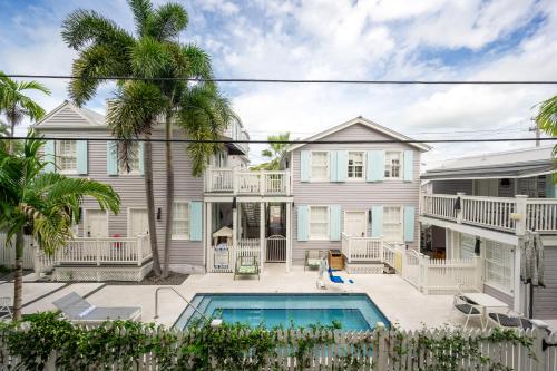 a house with a swimming pool and palm trees at Fitch Lodge - Key West Historic Inns in Key West