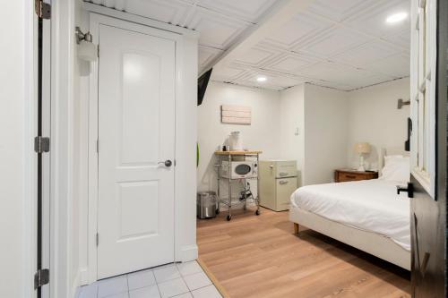 a bedroom with a bed and a white door at The Beachside in Sylvan Beach