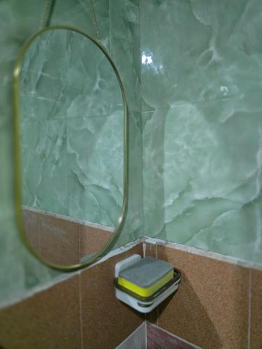 a bathroom with a shower with a mirror and a sink at 100 Luxury Air Con Studio Apartment with private balcony in Bangkok