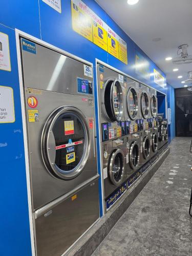 a row of washing machines in a laundry room at 100 Luxury Air Con Studio Apartment with private balcony in Bangkok