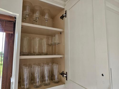a cupboard filled with lots of empty glass jars at Fiáin Retreat in Miltown Malbay