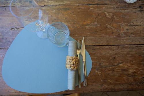 a table with a glass of wine and a pair of scissors at Camping Village Lago Maggiore in Dormelletto