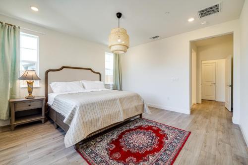 a bedroom with a bed and a red rug at 4 Mi to San Joaquin River Manteca Home with Patio! in Manteca