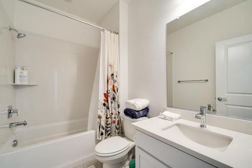 a bathroom with a sink and a toilet and a mirror at 4 Mi to San Joaquin River Manteca Home with Patio! in Manteca