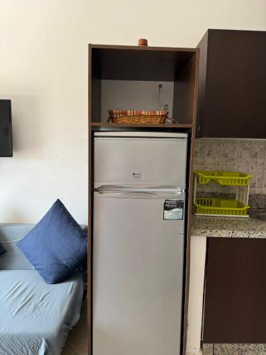 a refrigerator in a kitchen next to a bed at Cabo Dream 73 in Cabo Negro