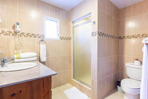 a bathroom with a toilet and a sink and a shower at Alicia Beach, Hispaniola Sol, great location - no car needed! in Sosúa