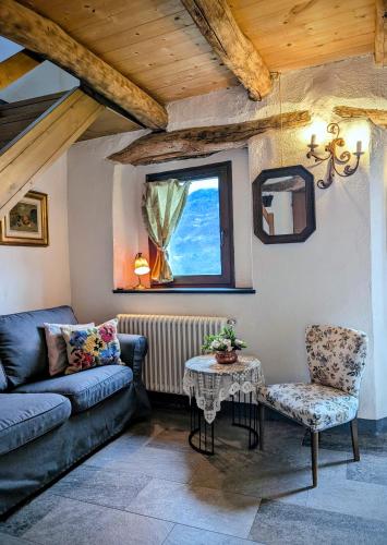 a living room with a couch and a table at Borgo Selvapiana in Morbegno