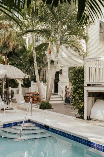a house with a swimming pool and palm trees at Ridley House - Key West Historic Inns in Key West