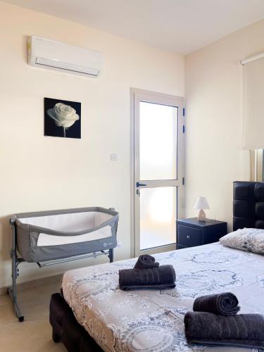 a bedroom with two beds and a window at Villa Merope Irena 1 in Polis Chrysochous