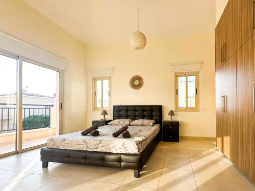 a bedroom with a bed and a large window at Villa Merope Irena 1 in Polis Chrysochous
