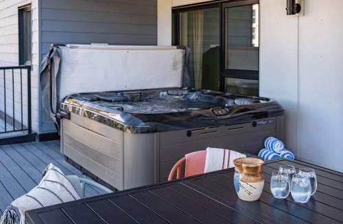 a grill sitting on a deck with a table at Sea Eagles Landing by Revelstoke Vacations in Revelstoke