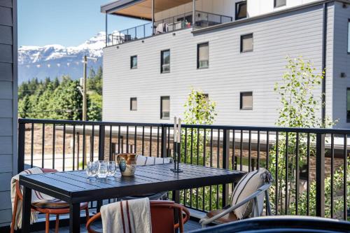a black table and chairs on a balcony at Sea Eagles Landing by Revelstoke Vacations in Revelstoke