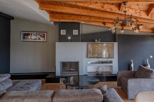 a living room with a couch and a fireplace at Paris Luxury Penthouse in Sarandë