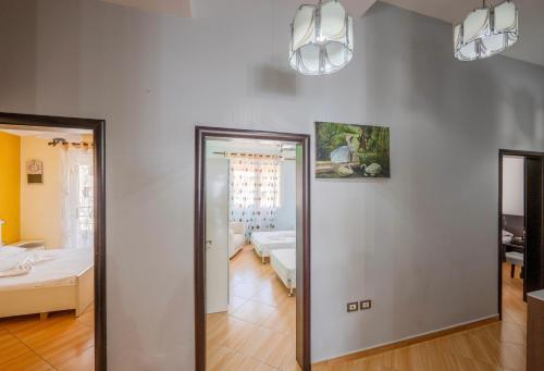 a hallway with a mirror in a room with a bed at Paris Luxury Penthouse in Sarandë