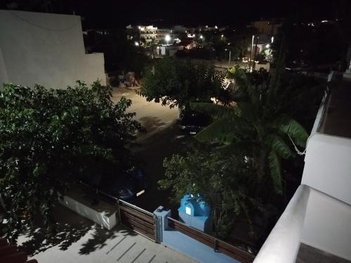 a view of a city at night with trees at Garifalia Studios in Kalamaki Heraklion