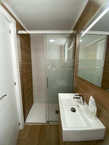 a bathroom with a white sink and a shower at Beachside Getaway in Zapillo in Almería