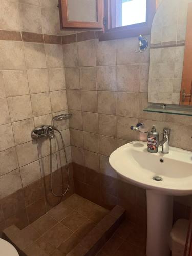 a bathroom with a sink and a shower at Hotel Kosmas in Sarti