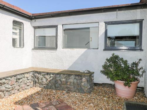 a house with a stone wall and a window at Harbour Road Quirky Beach Railway Carriages in Bognor Regis