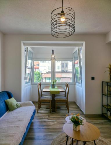 a living room with a table and a couch at Urban Nest in Jajce