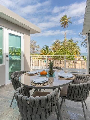 a dining room with a table and chairs at AQUA Terrazas Studio 7 - Beachfront Getaway with King Bed & Pool in Dorado