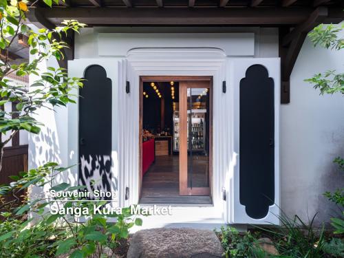 a entrance to a house with a white door at Mitsui Garden Hotel Kyoto Shinmachi Bettei in Kyoto