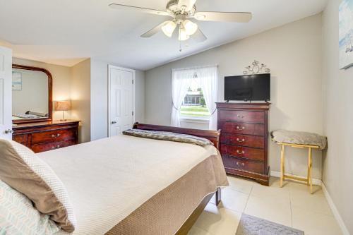 a bedroom with a bed and a flat screen tv at 1 Mi to Lake Jackson Home with Screened Patio! in Sebring