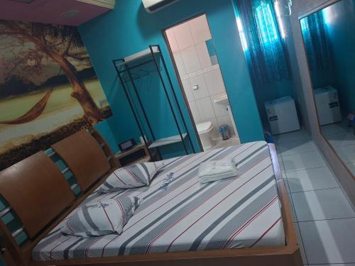 a bedroom with a bed with a painting on the wall at papillon hotel in Sao Paulo