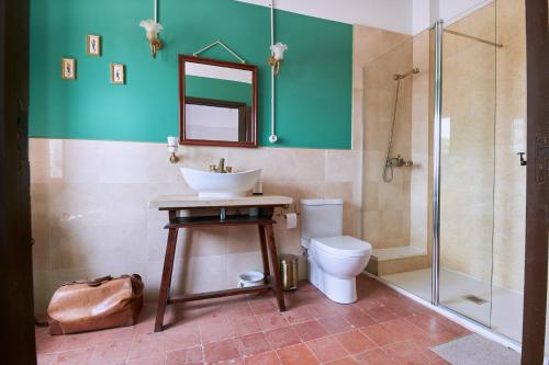 a bathroom with a sink and a toilet and a shower at Castell Granadella in L'Ampolla