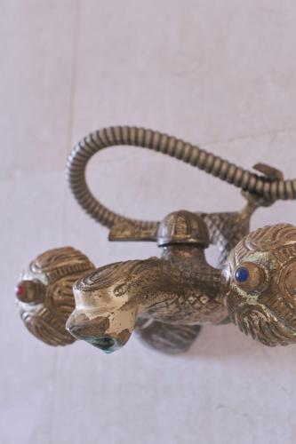 a bronze chime of an animal on a wall at Castell Granadella in L'Ampolla