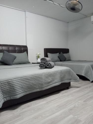 a bedroom with two beds and a ceiling at Chalet Barokah Seaview in Bachok