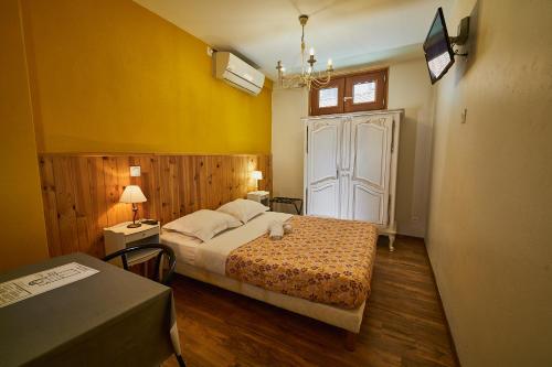 a bedroom with a large bed and a window at La Caravelle in Riom
