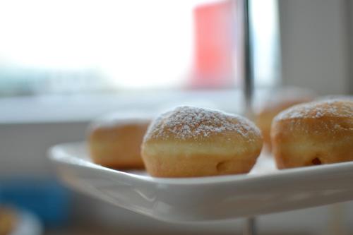 a plate of donuts with powdered sugar on it at Hotel Vienna in Pesaro