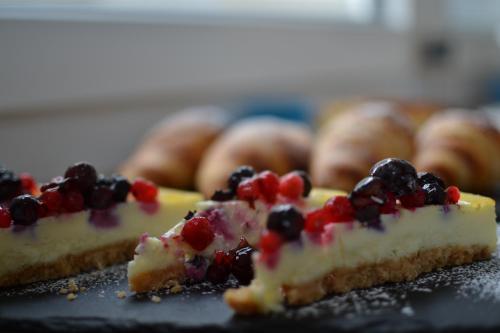 a close up of a piece of cake with berries on it at Hotel Vienna in Pesaro