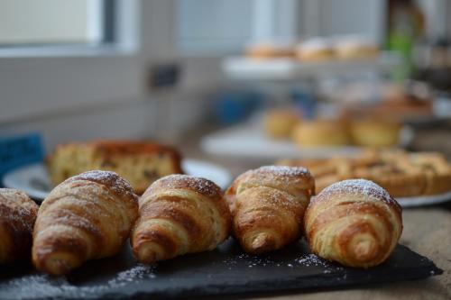 a bunch of pastries sitting on a black tray at Hotel Vienna in Pesaro
