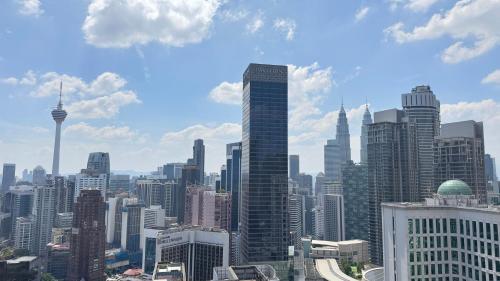 a view of a large city with tall buildings at Axon Residence Near Fehrenheit Bukit Bintang in Kuala Lumpur
