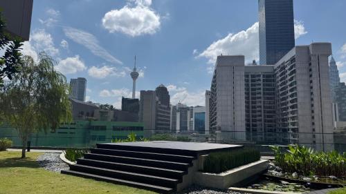 a group of stairs in a city with buildings at Axon Residence Near Fehrenheit Bukit Bintang in Kuala Lumpur