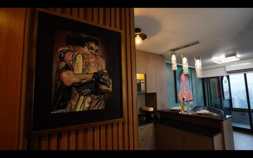 a painting of a baseball player hanging on a wall at Sweet apartment frente al metro Irarrazaval in El Cerrillo