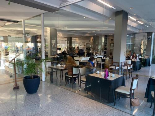 a restaurant with people sitting at tables in a building at Dr Cesar Carman in Cordoba