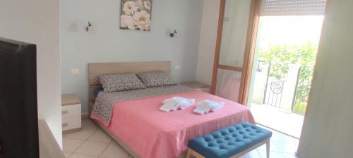 a bedroom with a bed with two towels on it at APPARTAMENTI RIMINI NEL CUORE in Rimini