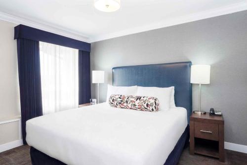 a bedroom with a large bed with a pillow on it at Sandman Signature Prince George Hotel in Prince George