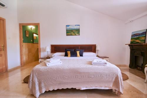 a bedroom with a large bed with towels on it at Castell Granadella in L'Ampolla