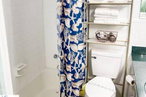 a bathroom with a toilet and a shower curtain at Stylish Studio Ocean View in Daytona Beach