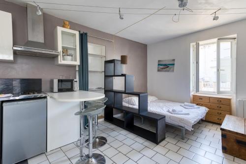 a kitchen with a sink and a bed in a room at studio in Bourcefranc