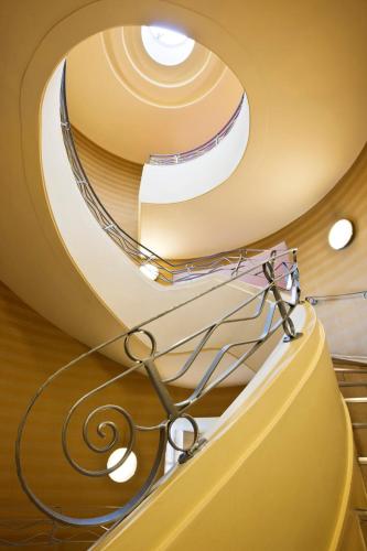 a spiral staircase in a building with a pair of scissors at Crowne Plaza Liverpool - John Lennon Airport by IHG in Liverpool