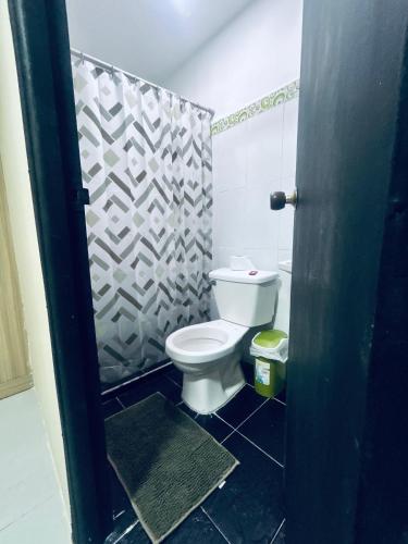 a bathroom with a toilet and a shower stall at Posada Francelly in San Andrés